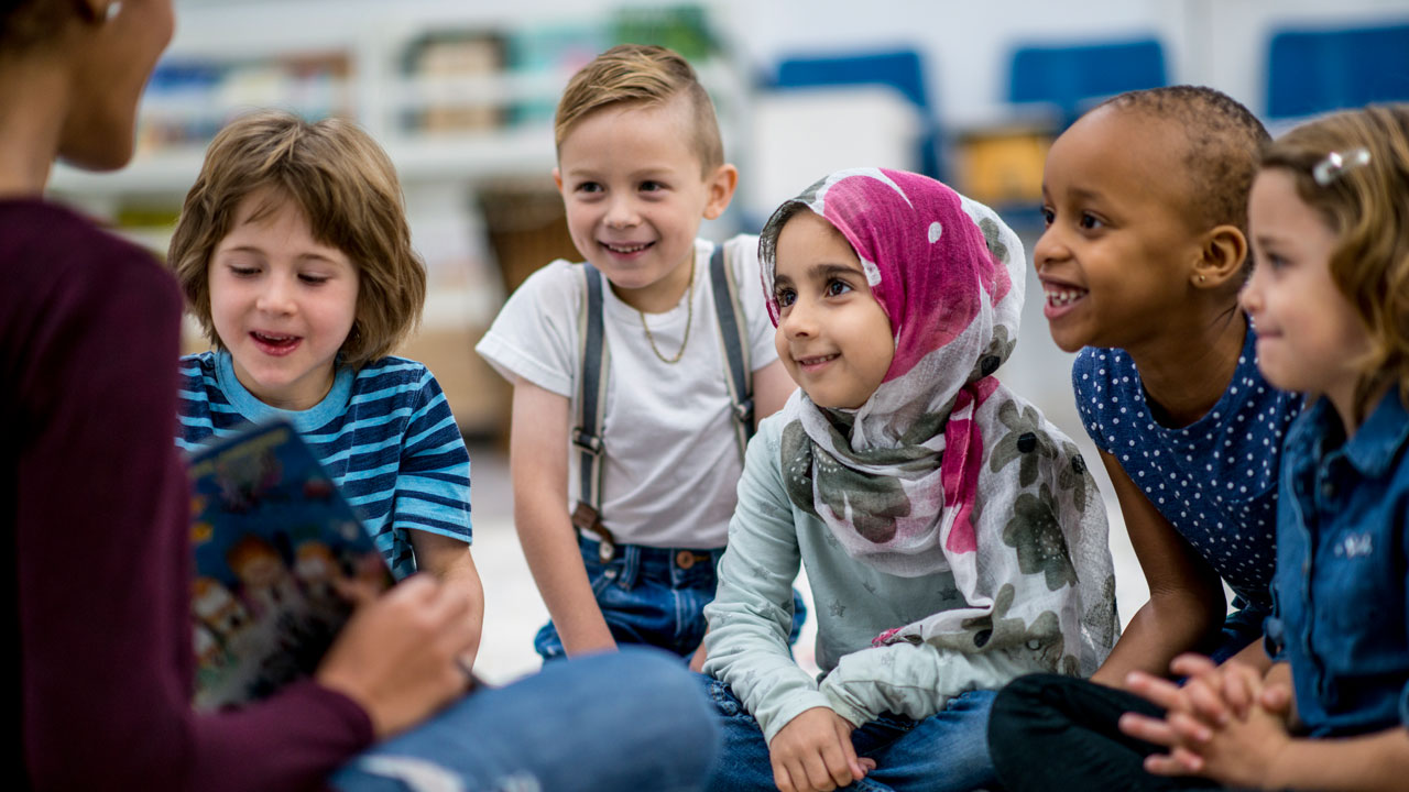 Teacher reading to young students