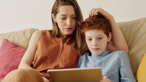 Boy and mother looking at iPad together