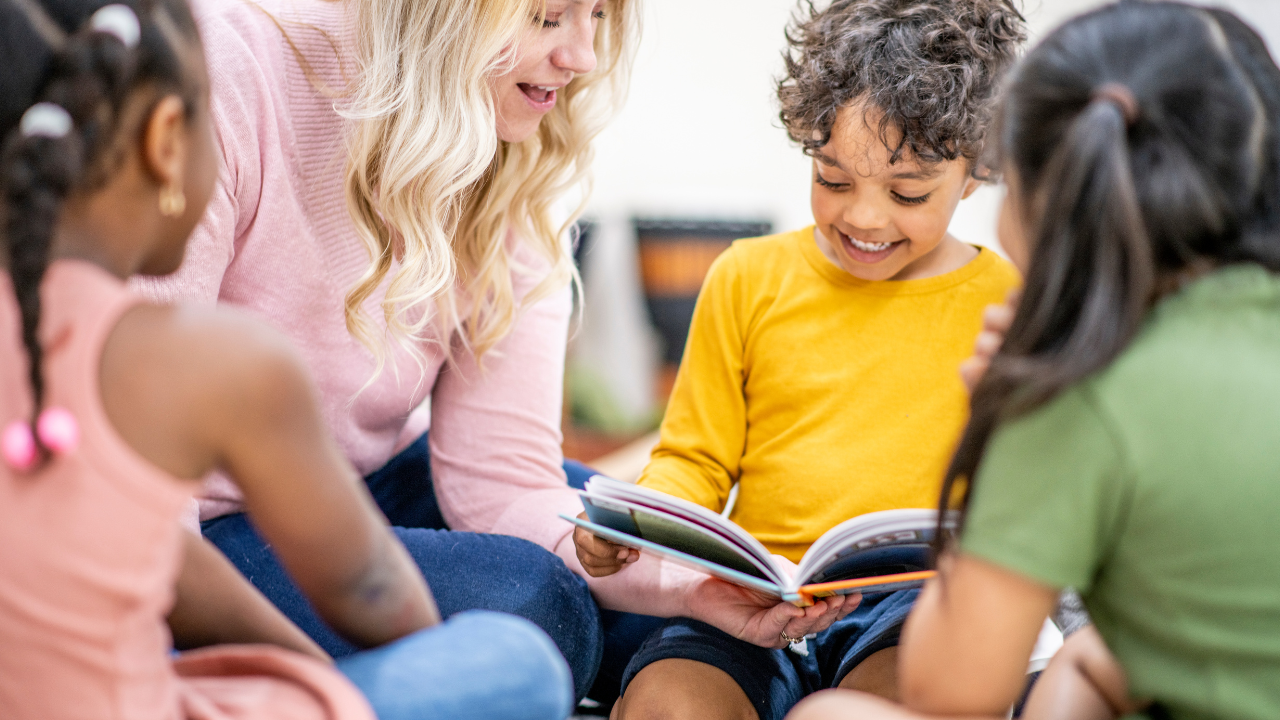 Kindergarten teacher reads book with students